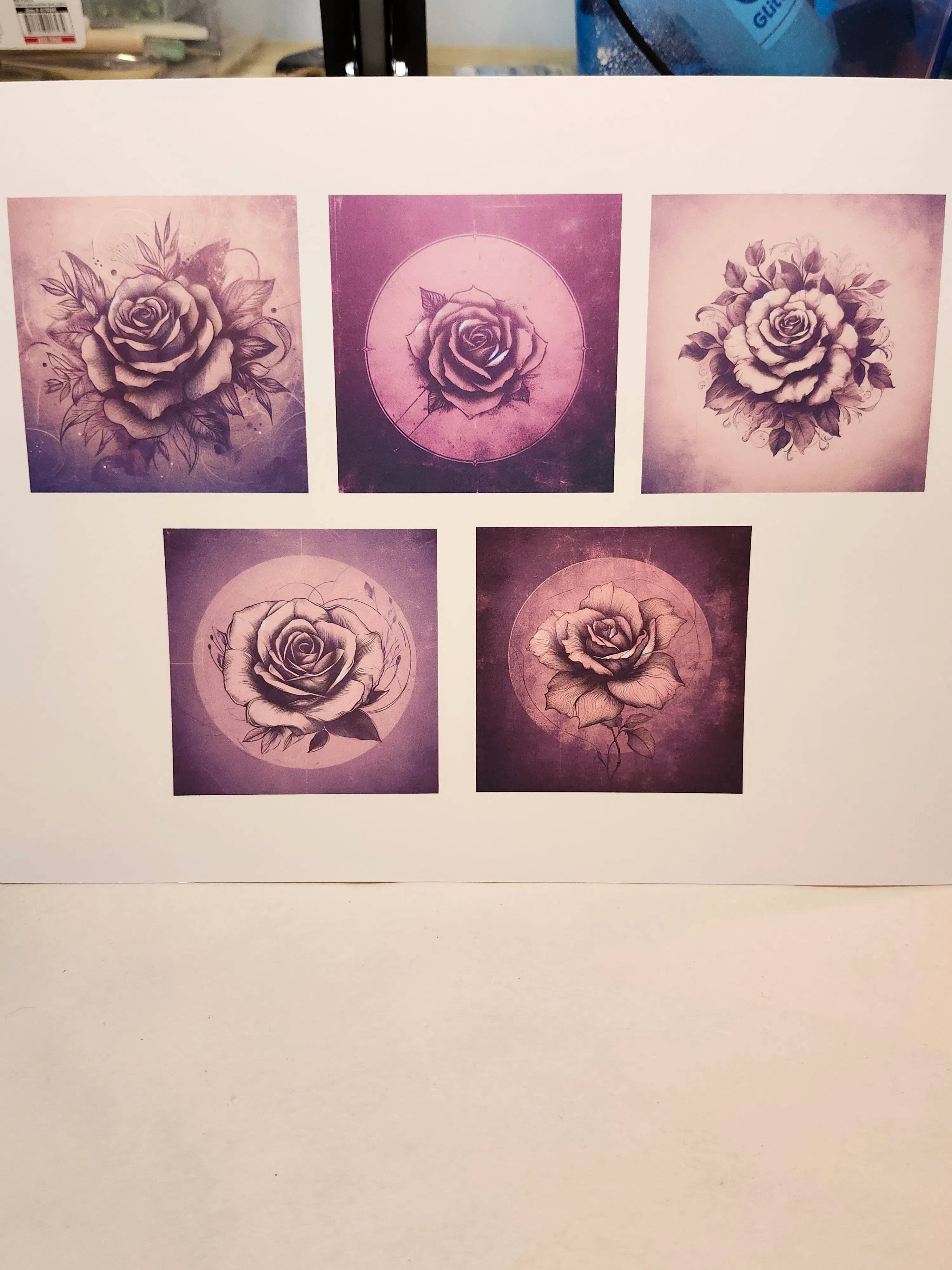 Five purple rose tattoos on a white paper background