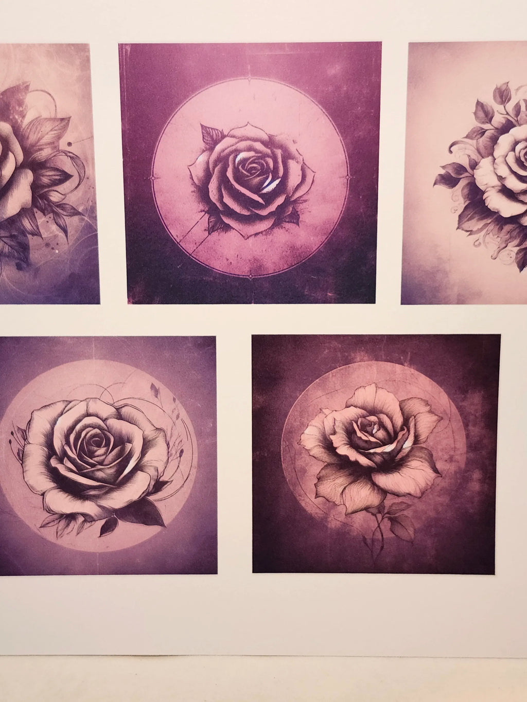 Four framed black and white rose prints on a wall.