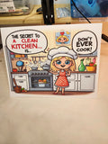 Cartoon card with a character in a kitchen and humorous text about cleaning a kitchen.