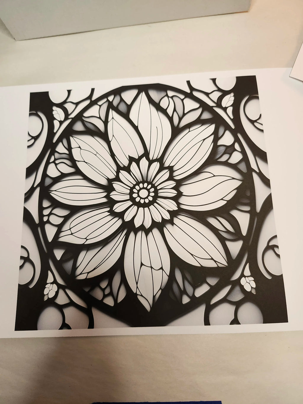 Black and white floral mandala design on a white background