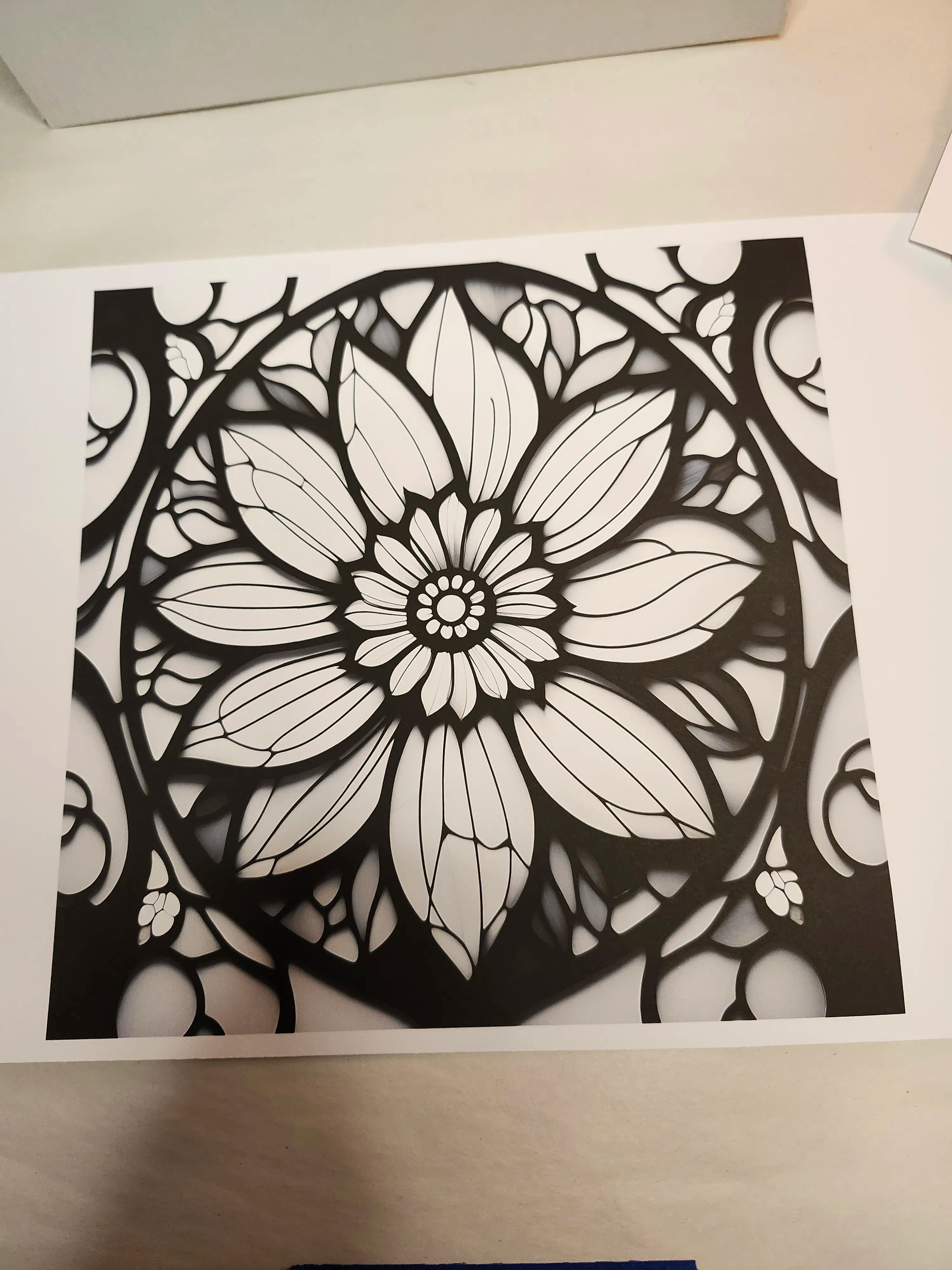 Black and white floral mandala design on a white background