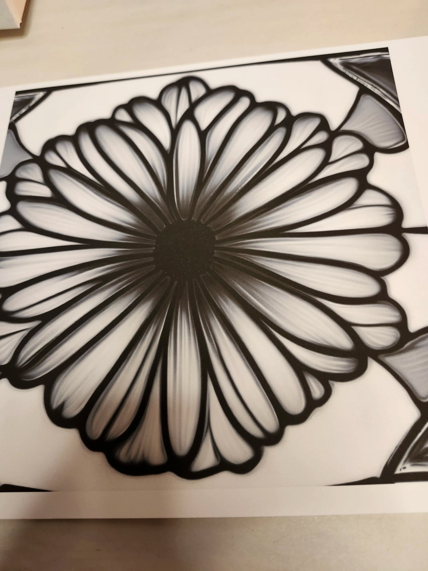 Black and white floral design on a textured surface
