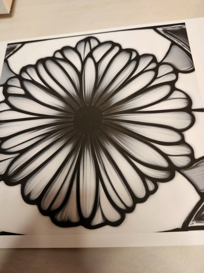Black and white floral design on a textured surface