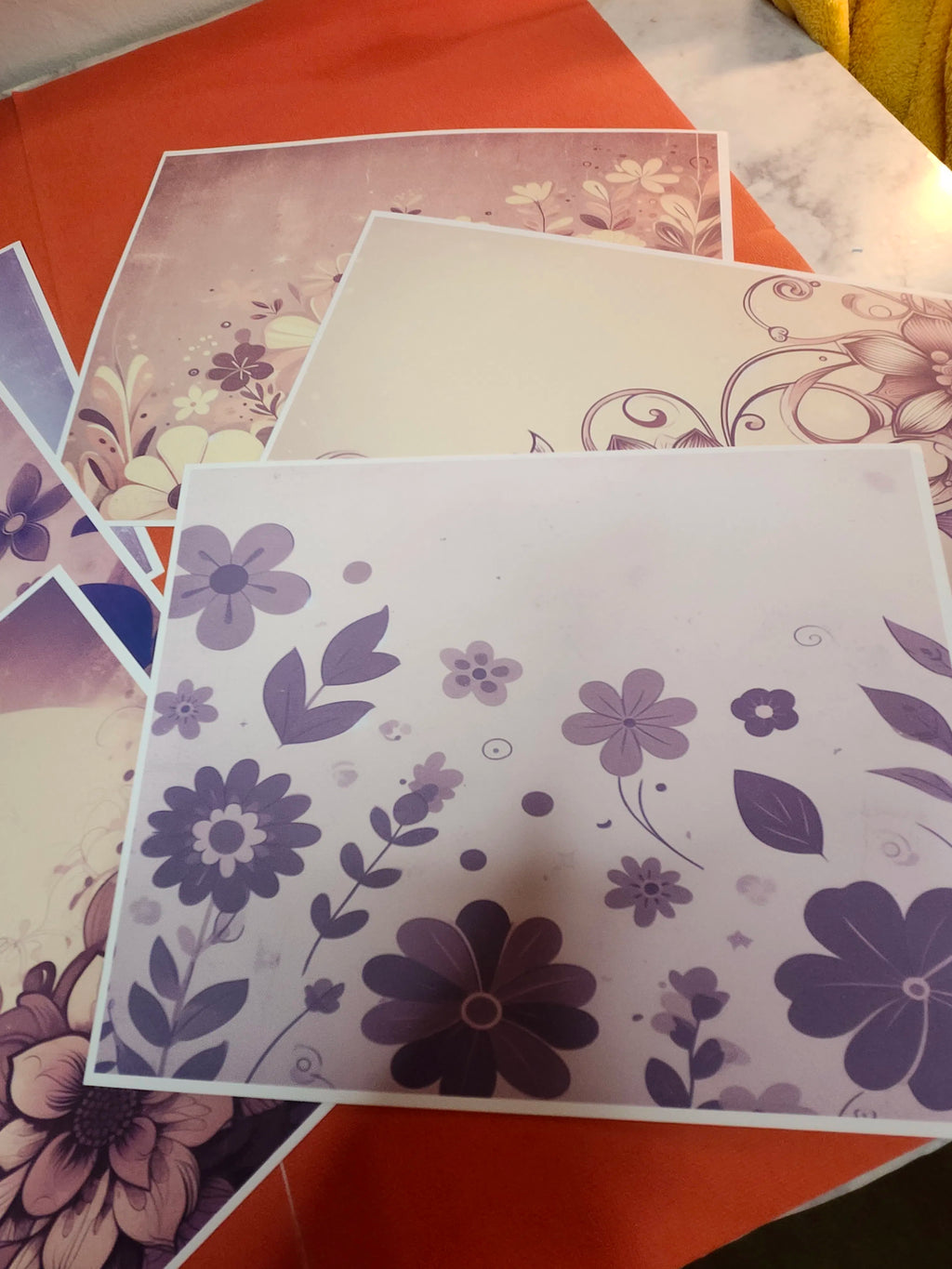 Floral patterned paper sheets on a colorful background
