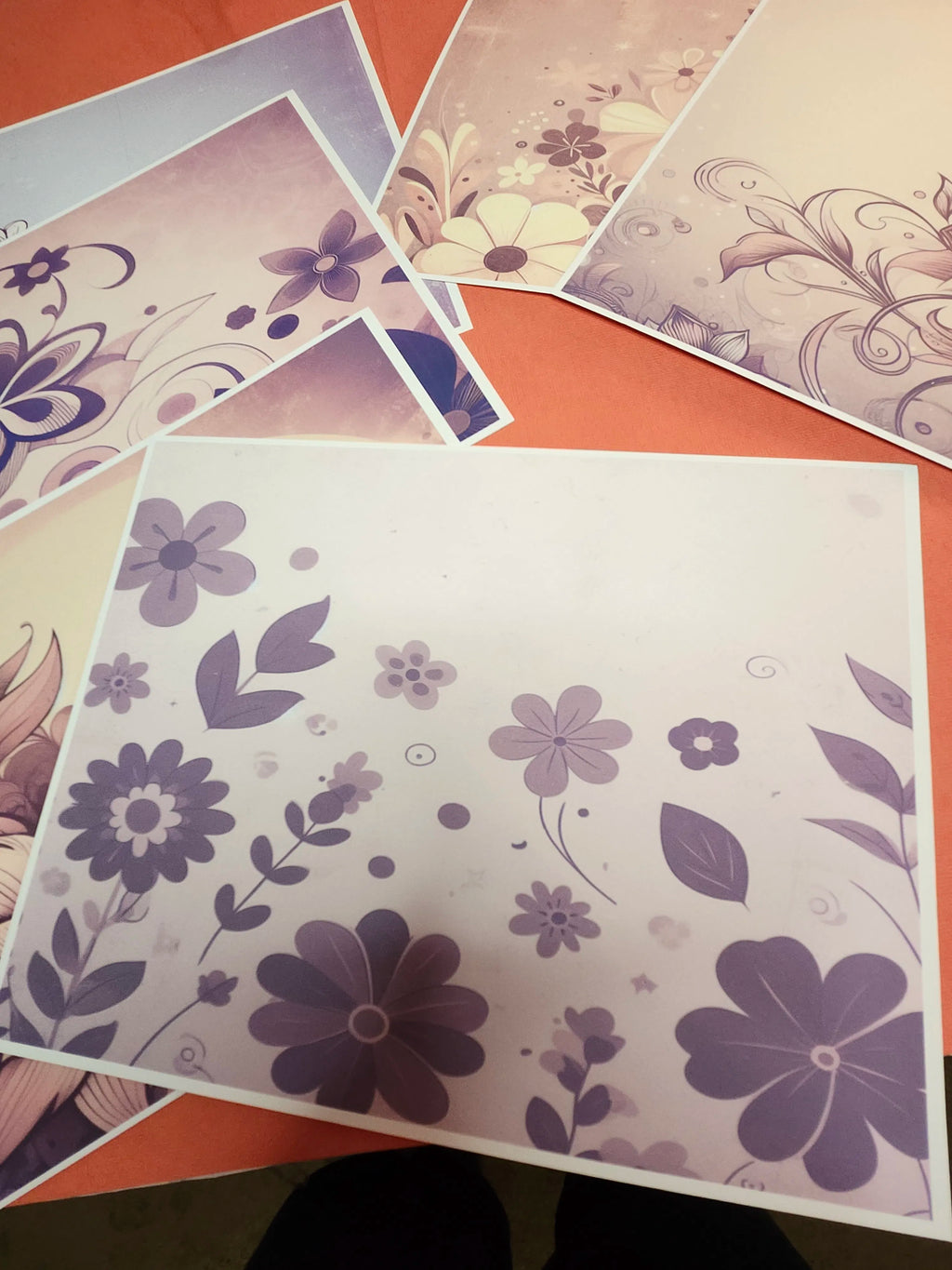 Floral patterned paper sheets on a flat surface