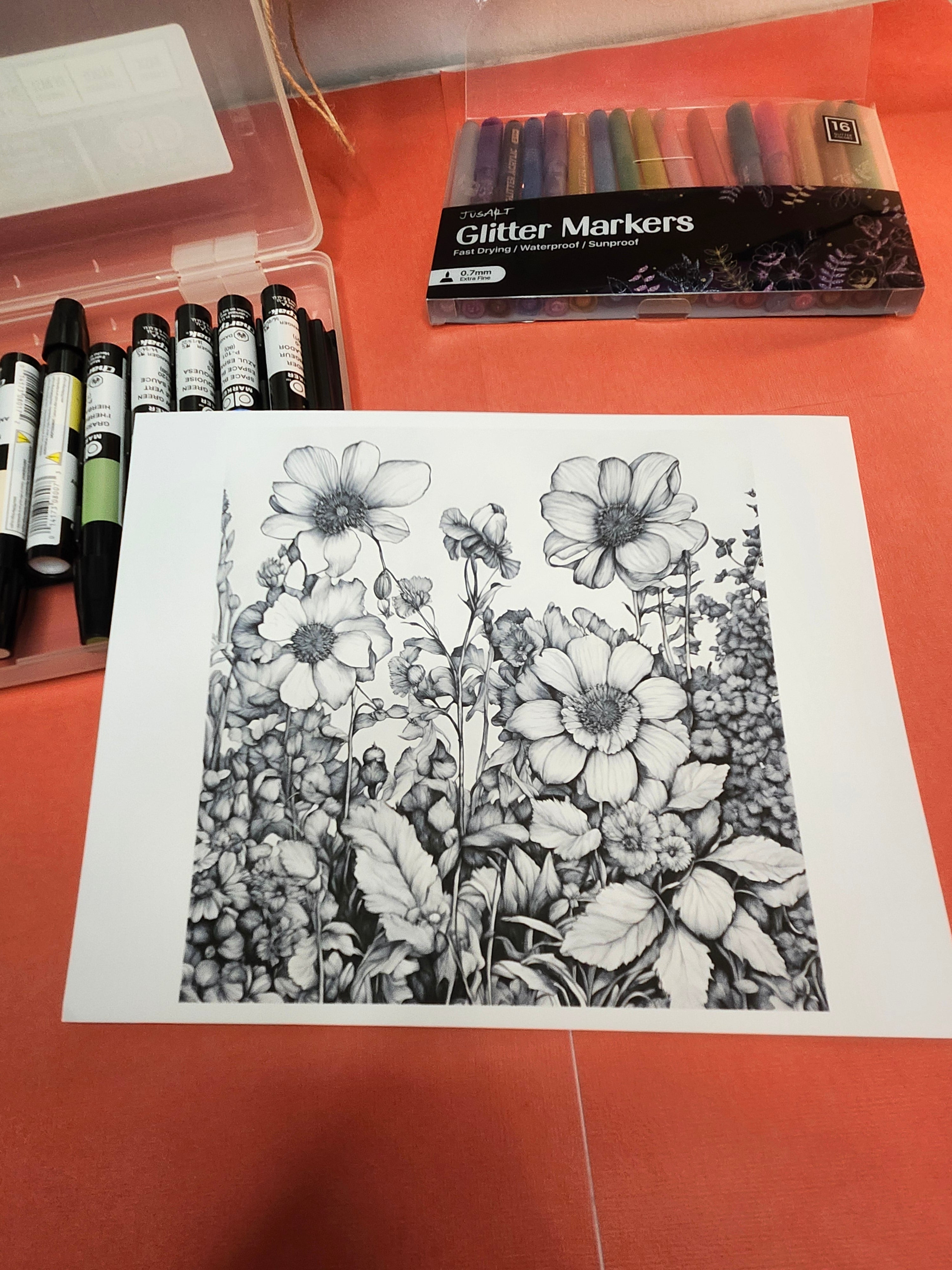 Floral drawing on paper with glitter markers and colored pencils on a red surface