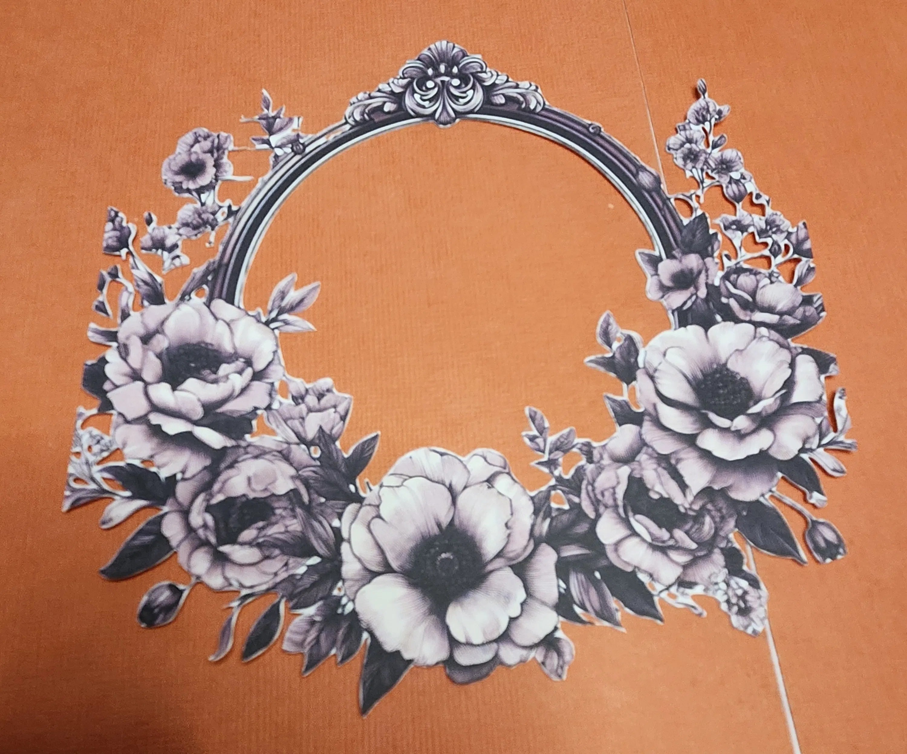 Decorative floral wreath on an orange background
