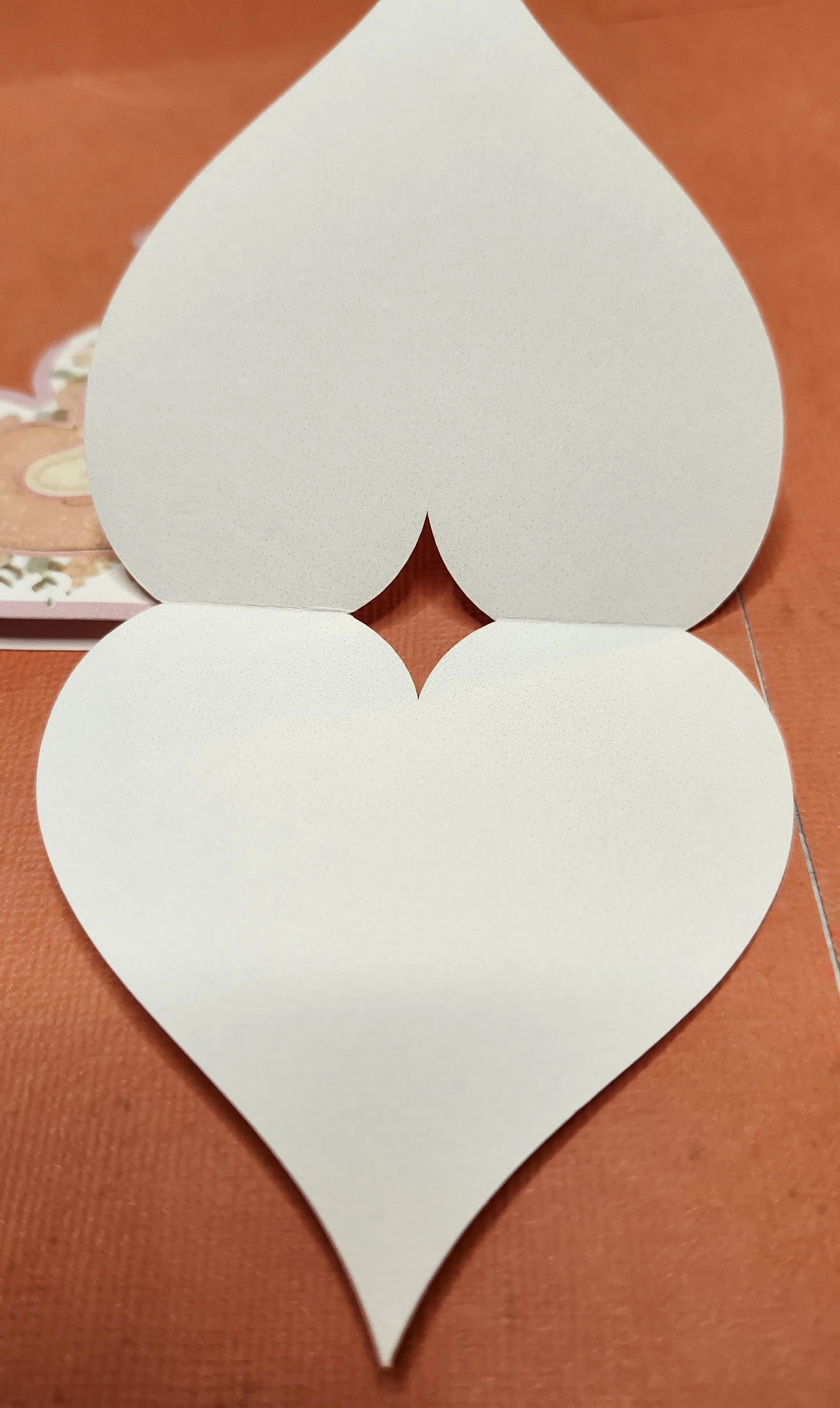 White heart-shaped object on a brown background
