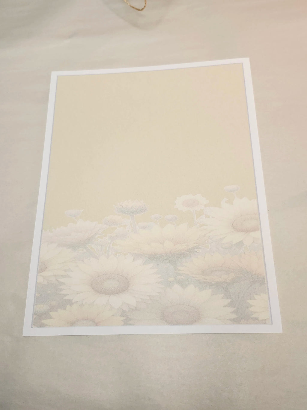 Framed artwork of a floral design on a beige wall