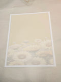 Framed artwork of a floral design on a beige wall