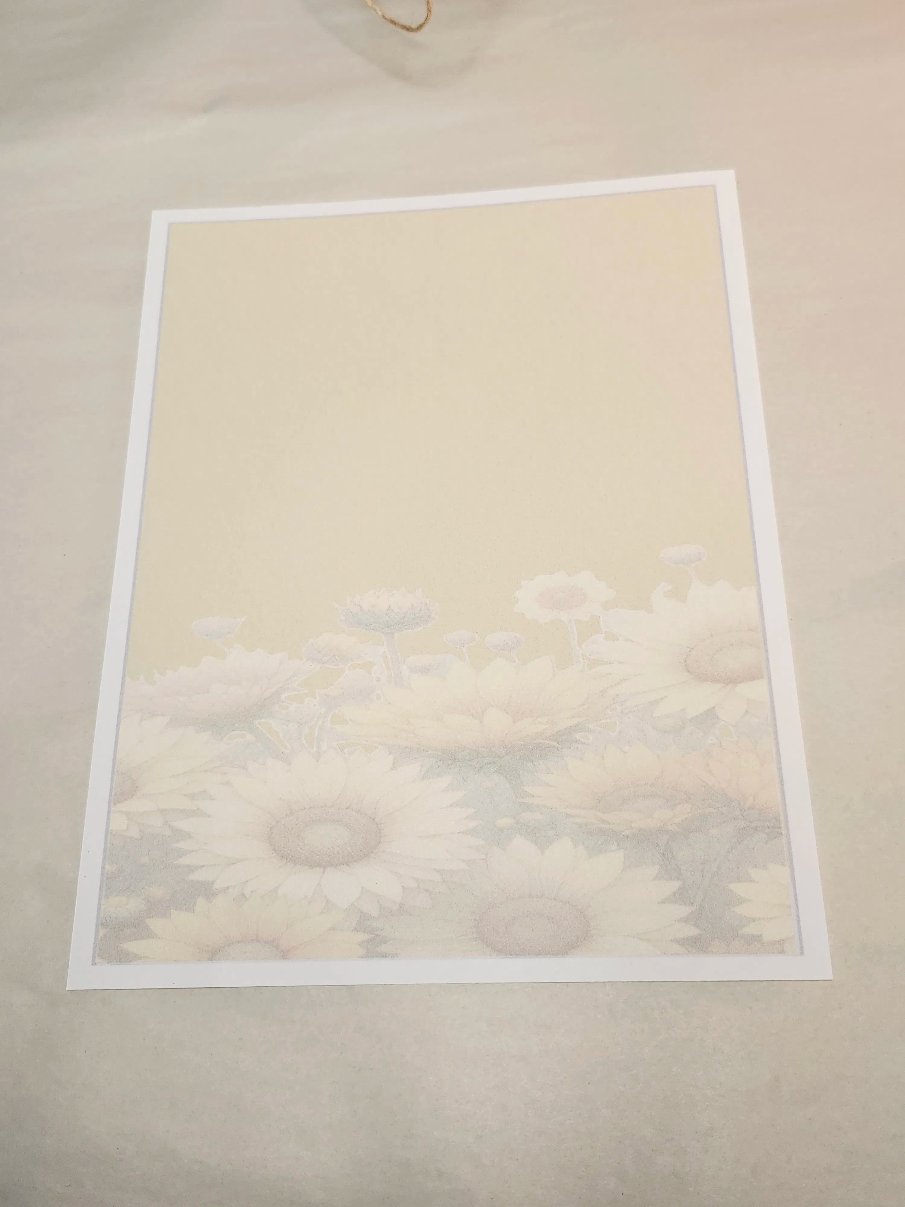 Framed artwork of a floral design on a beige wall