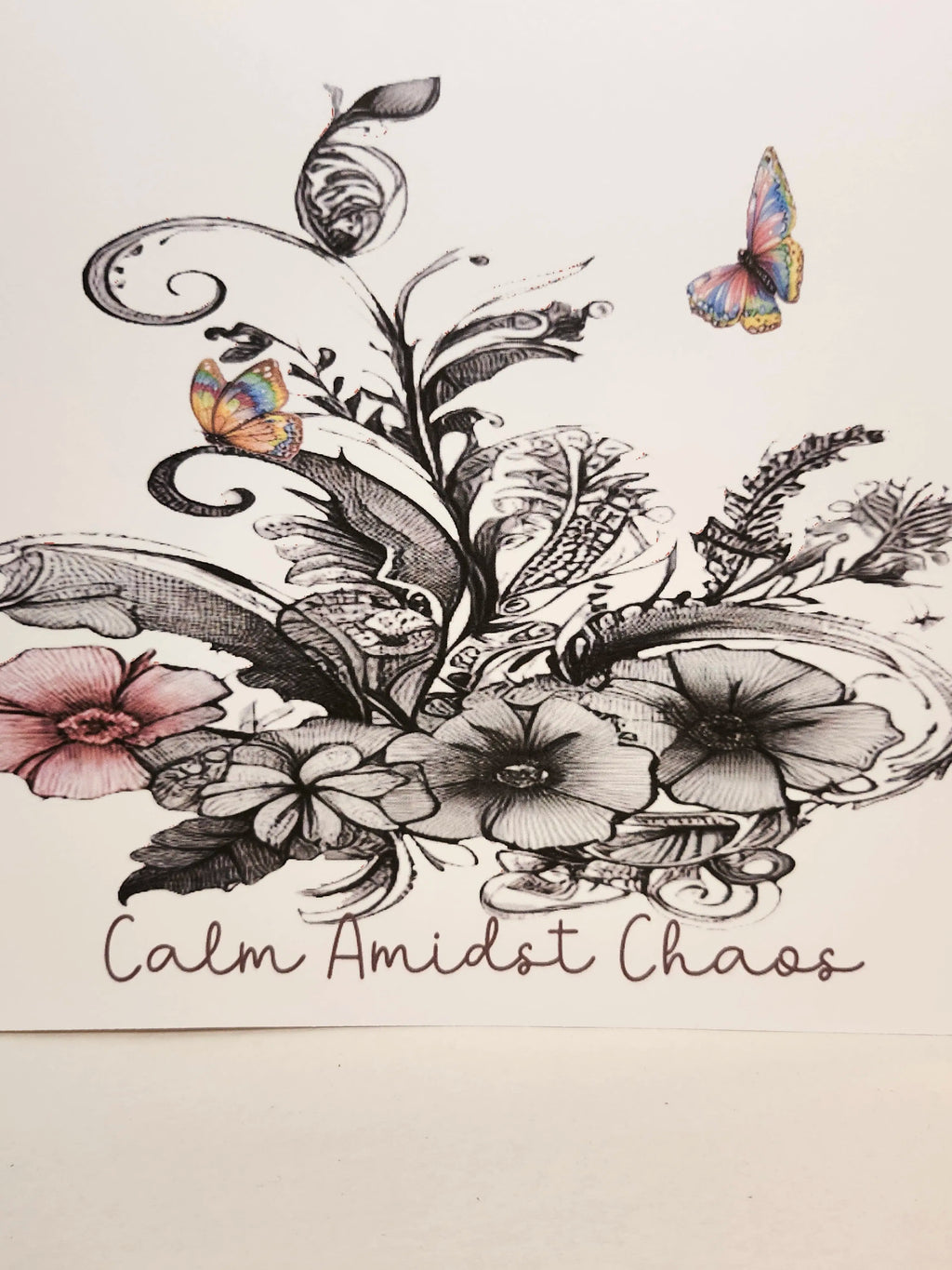Decorative design with flowers, leaves, and butterflies on a light background with 'Calm Amidst Chaos' text.