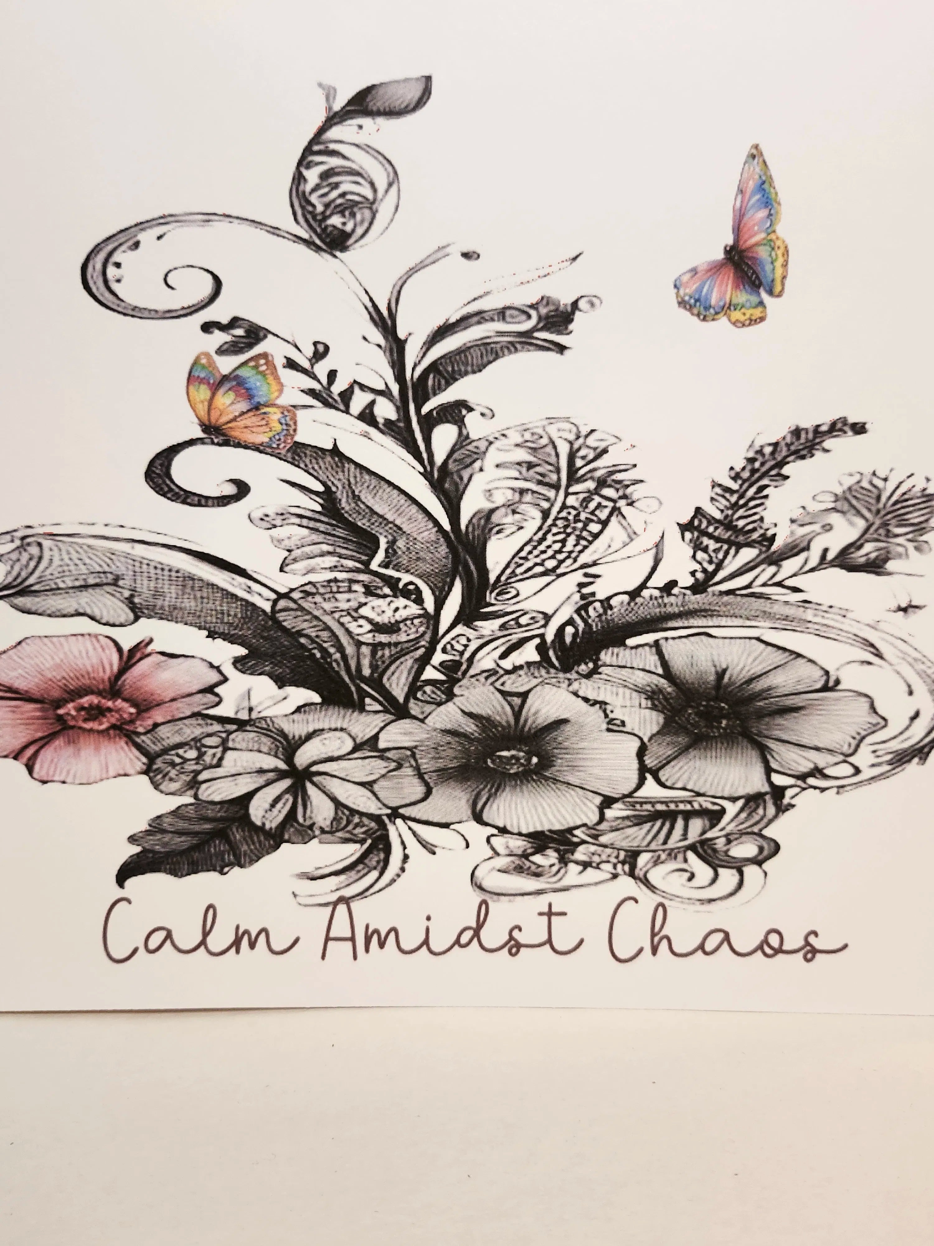 Decorative design with flowers, leaves, and butterflies on a light background with 'Calm Amidst Chaos' text.