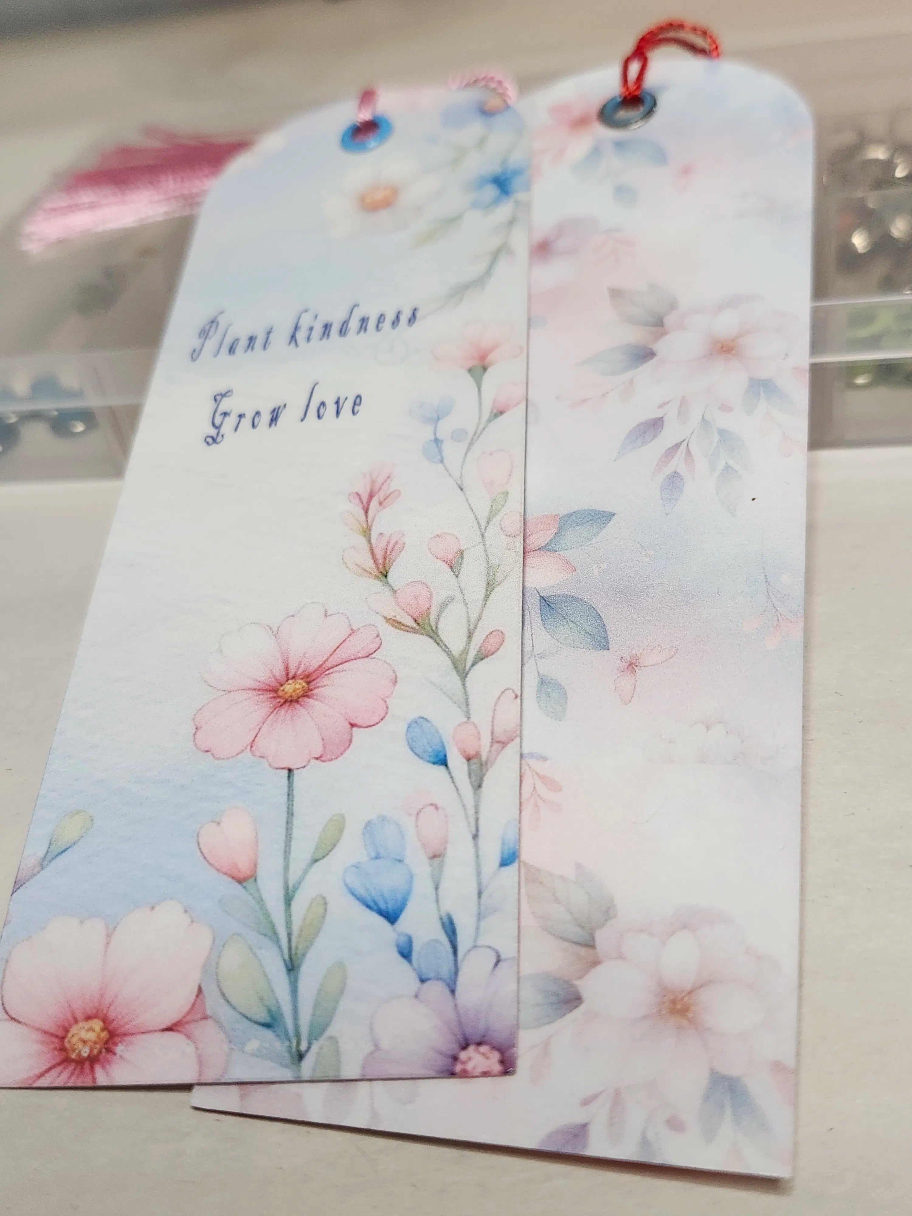 Two floral bookmarks with pink and blue flowers on a white background.
