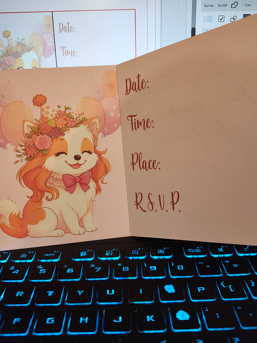 Invitation card with a cartoon dog and RSVP text on a keyboard