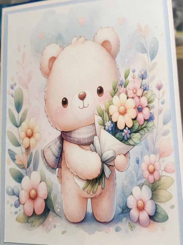 Card with a cute bear holding flowers on a floral background