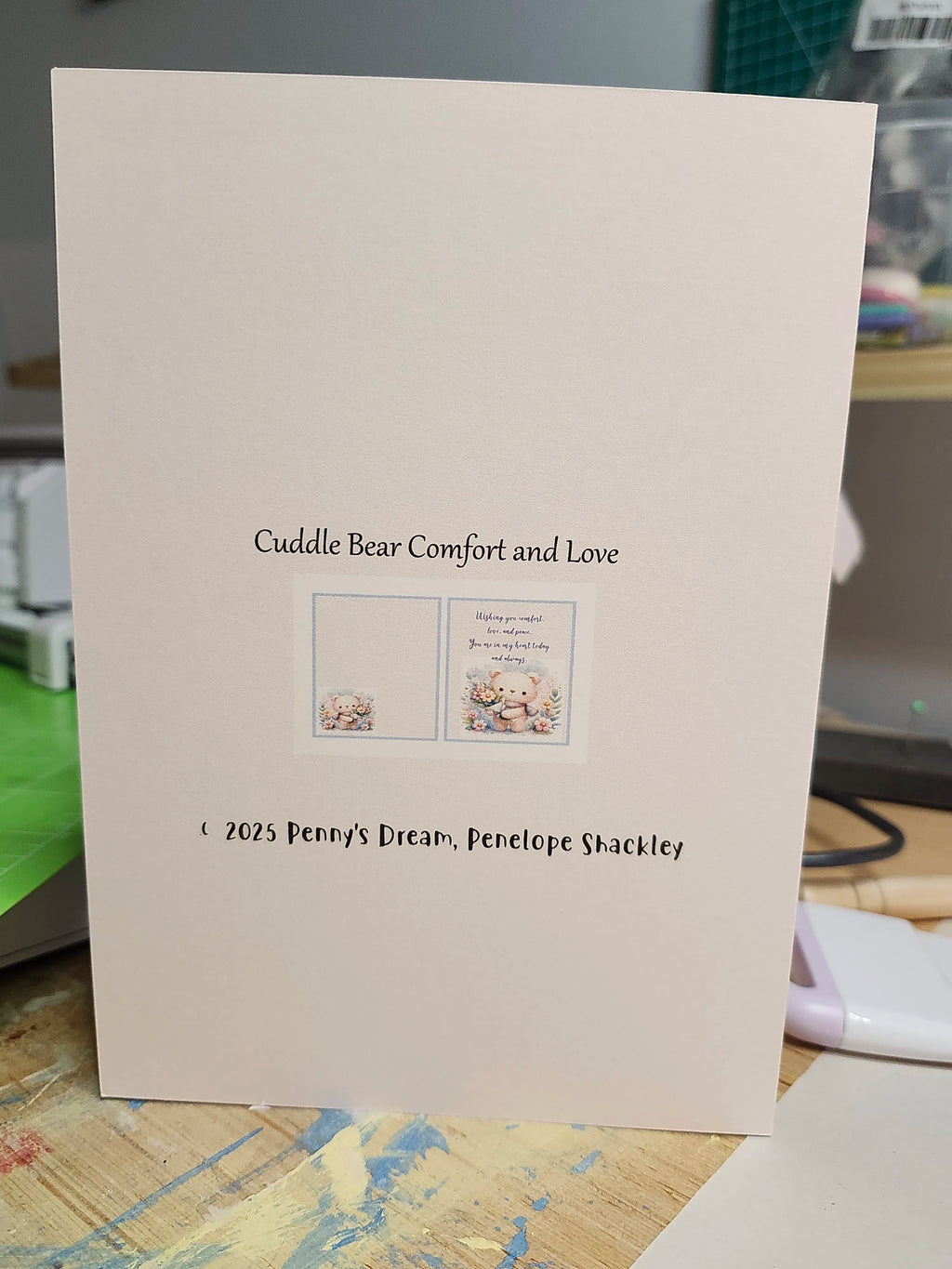 Card with text 'Cuddle Bear Comfort and Love' by Penny's Dream on a neutral background
