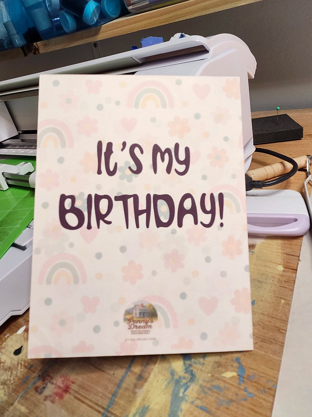 Card with 'It's my birthday!' text on a desk with office supplies.