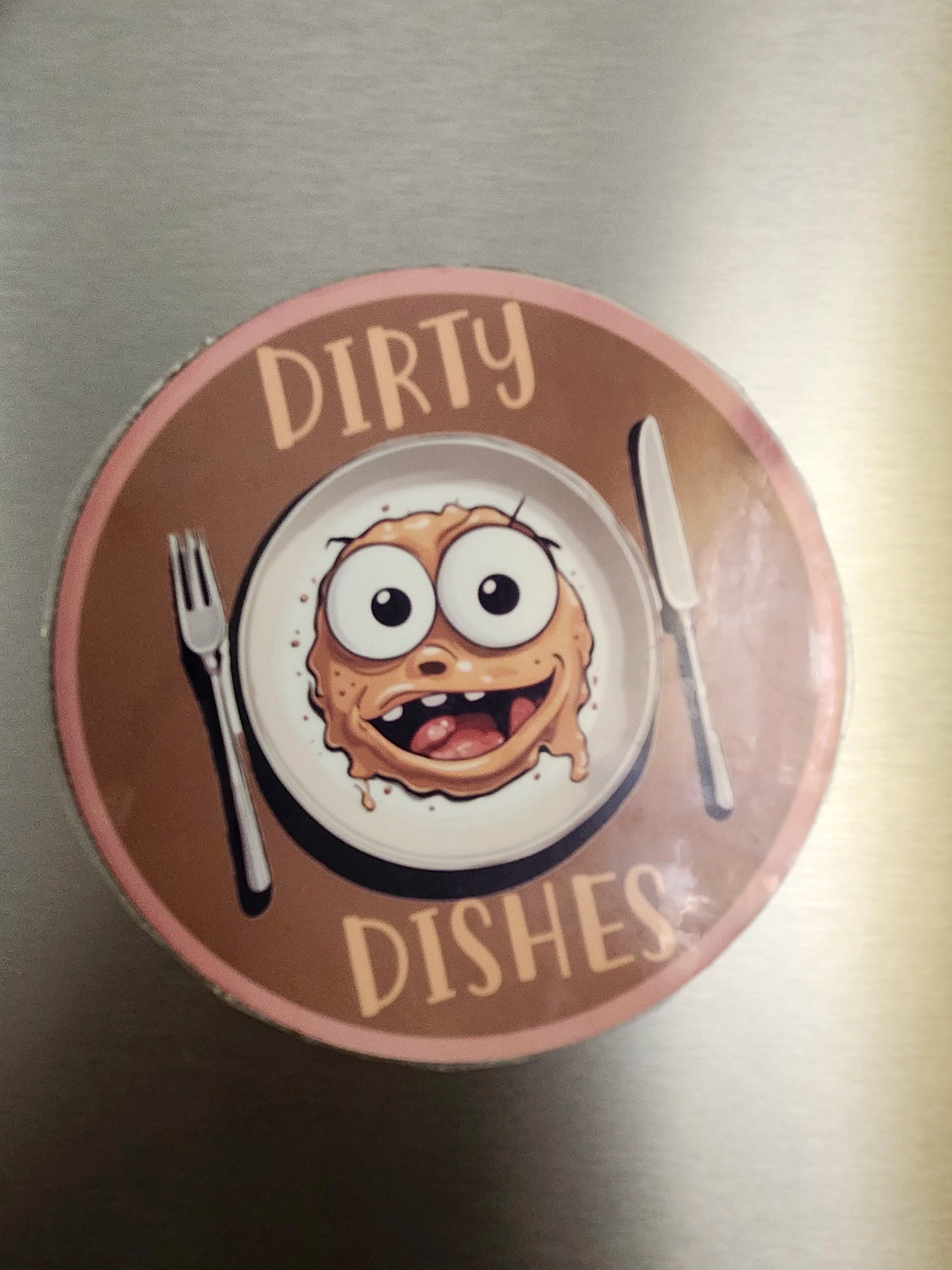 Circular sign with cartoon plate and text 'Dirty Dishes' on a metallic surface