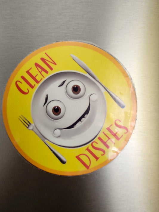 Circular magnet with cartoon character and 'Clean Dishes' text on a metallic surface
