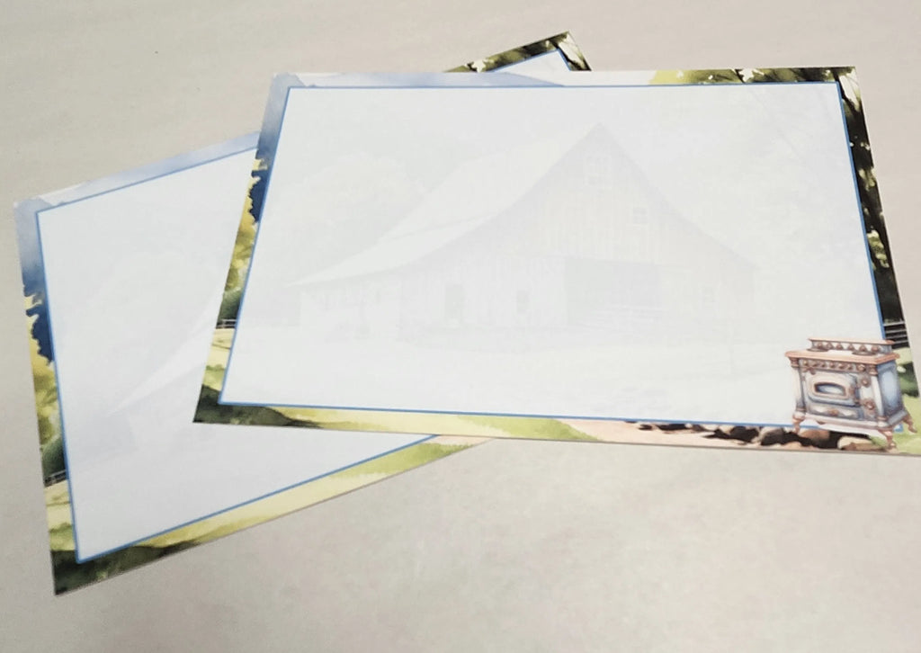 Two blank greeting cards with scenic designs on a gray surface