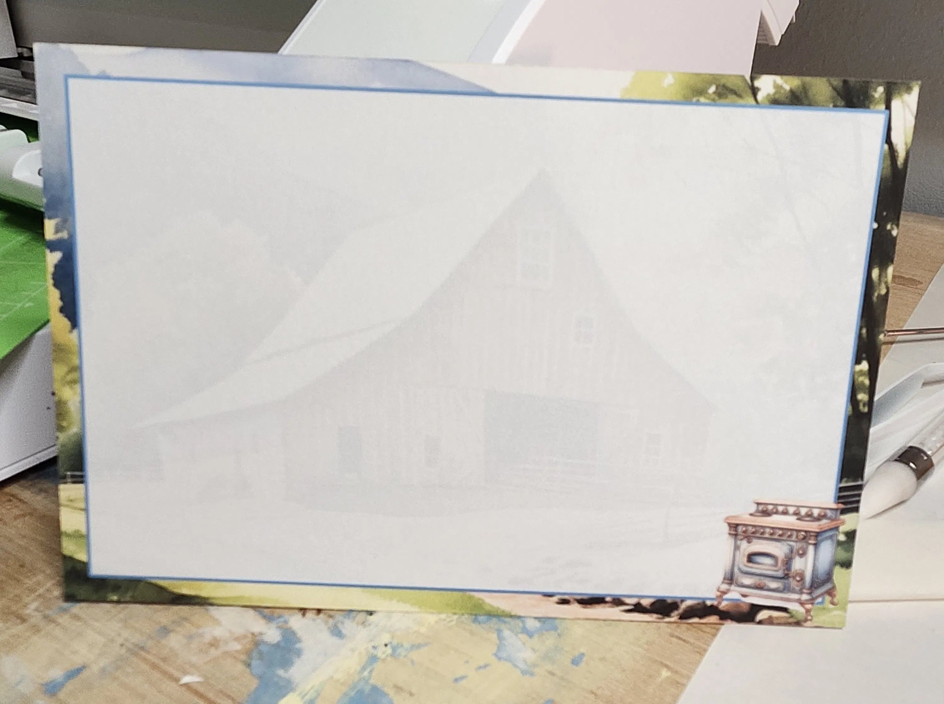 White paper with decorative border on a wooden surface