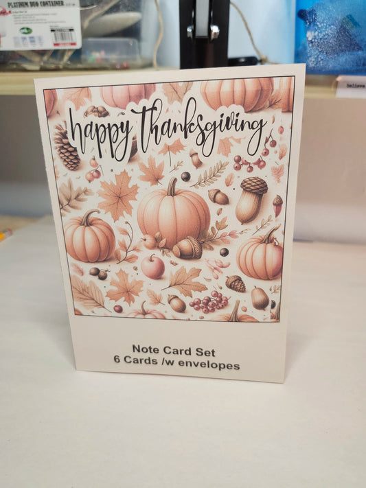 Note card set with 'Happy Thanksgiving' design featuring pumpkins and fall elements on a white surface.