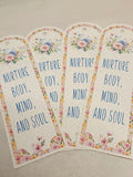 Four floral-themed tags with text on a neutral background