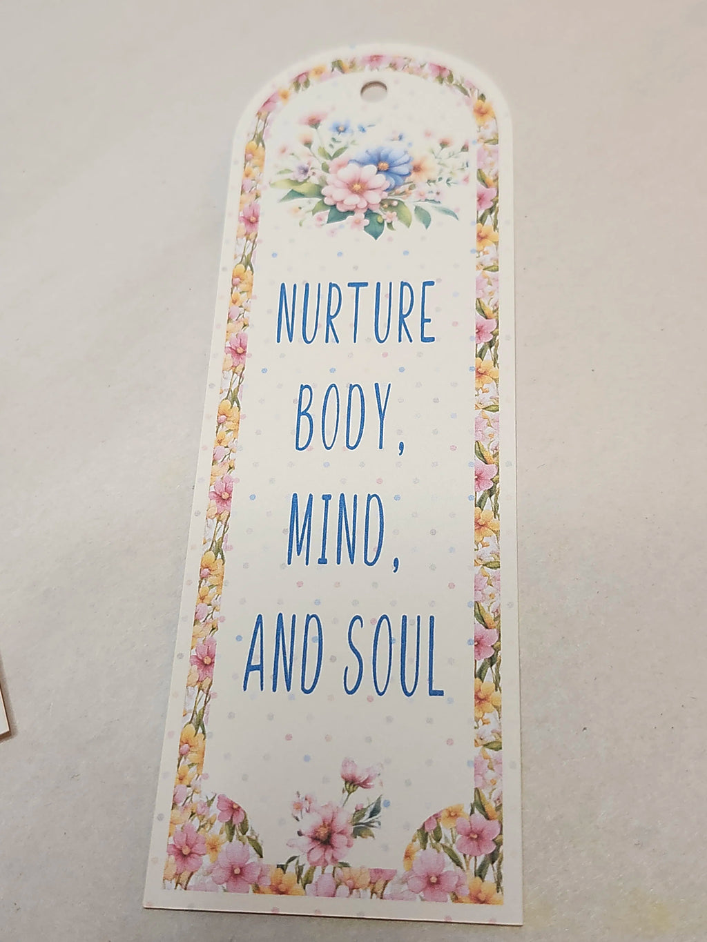 Floral bookmark with motivational quote on a light background