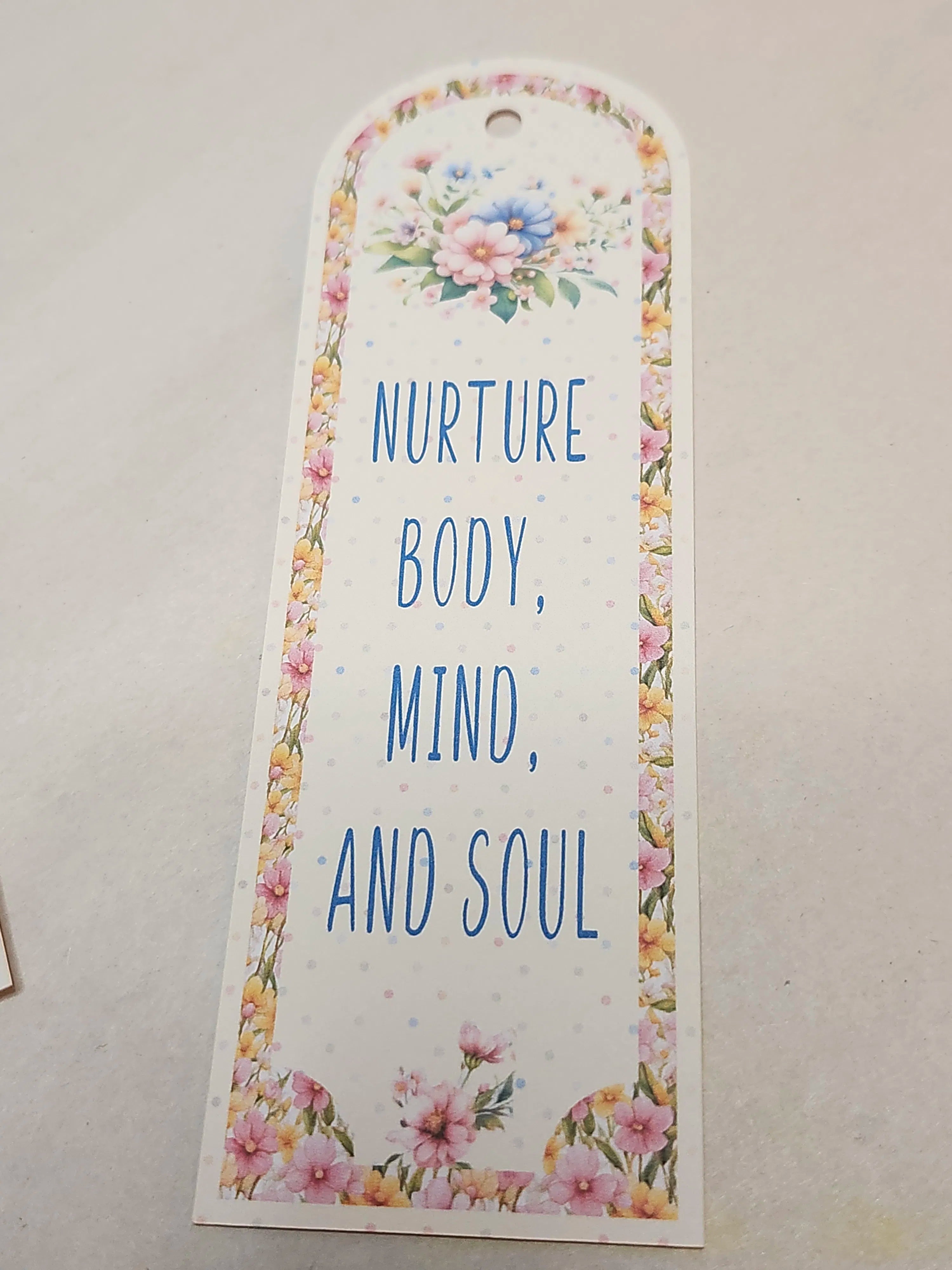 Floral bookmark with motivational quote on a light background