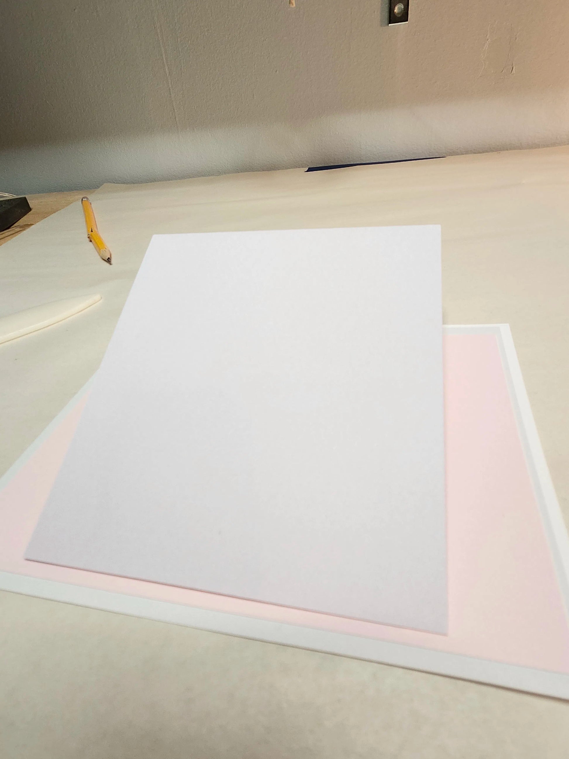 White paper on a light-colored surface with a pencil to the left.