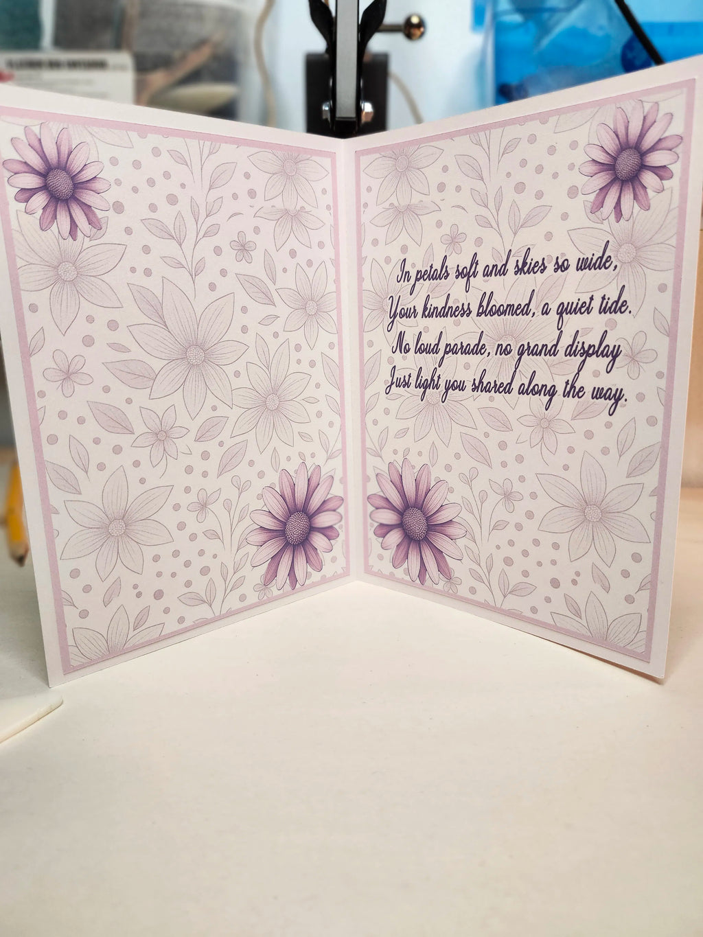 Greeting card with floral design and text on a white surface