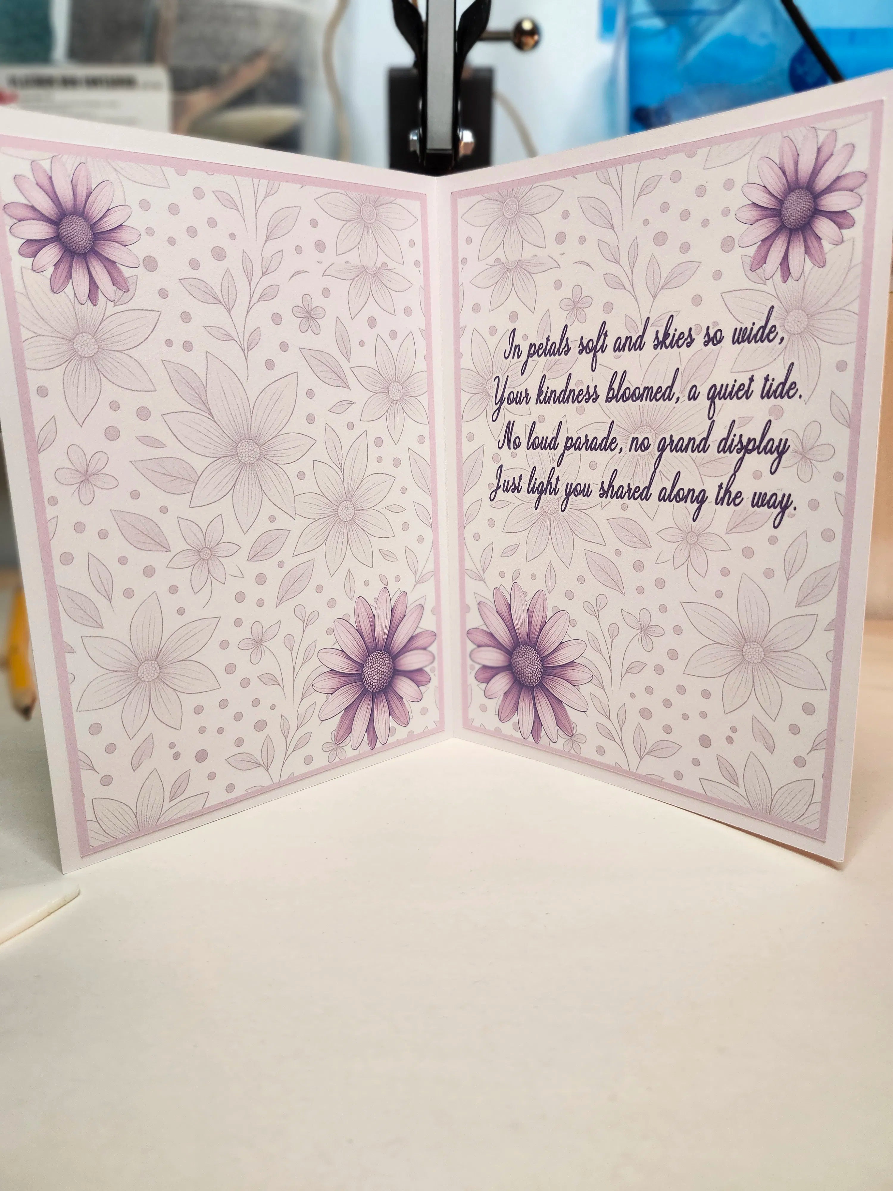 Greeting card with floral design and text on a white surface