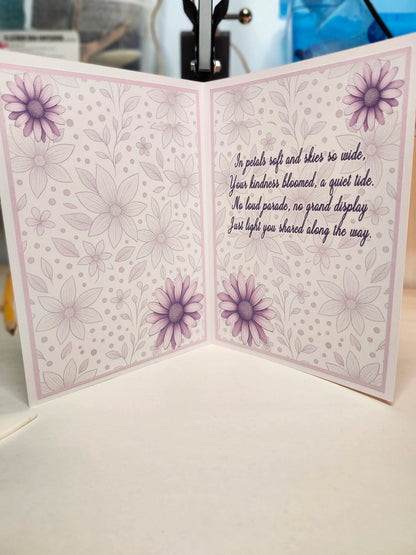 Greeting card with floral design and text on a white surface
