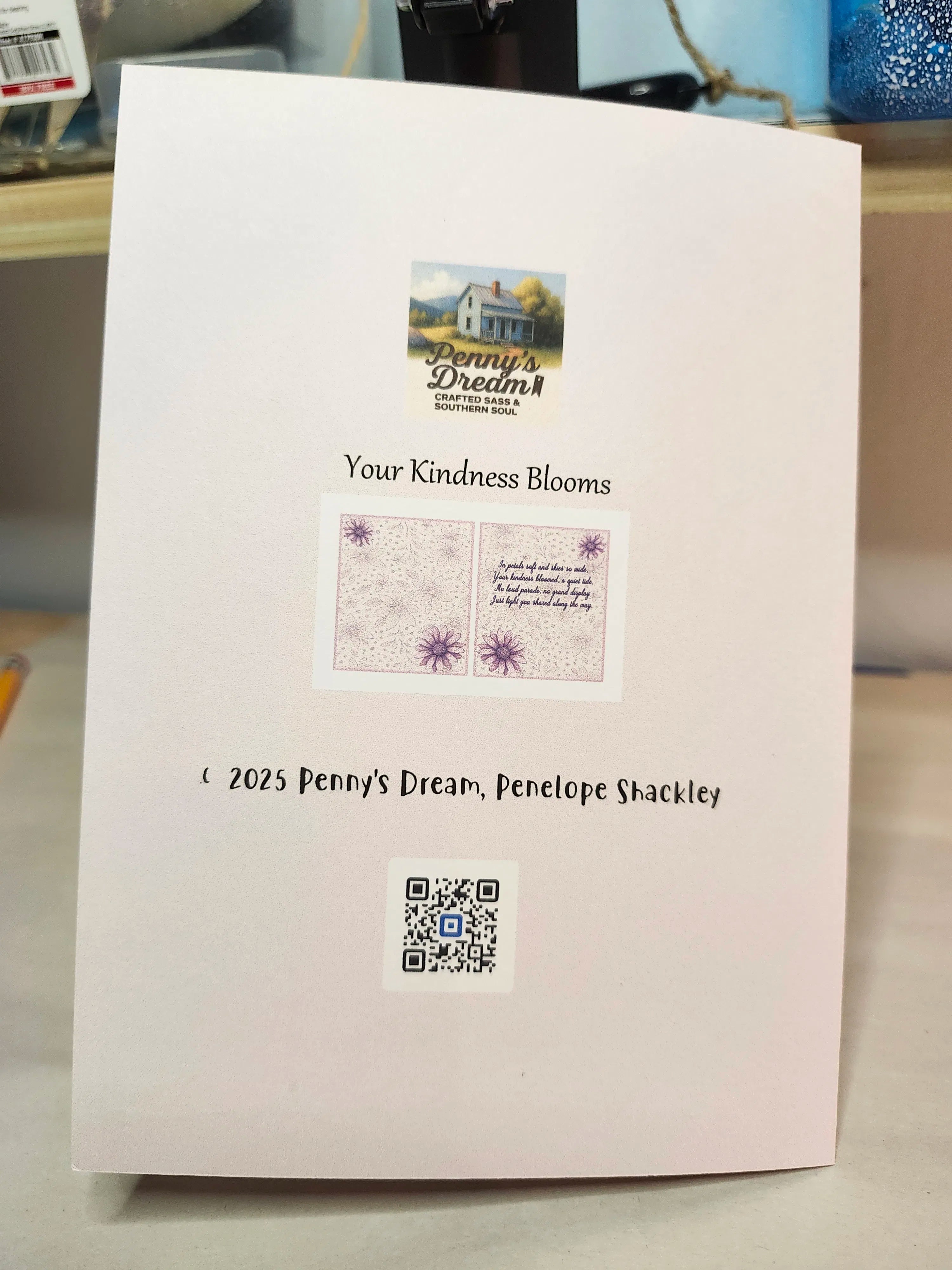 Book or notebook with 'Penny's Dream' branding and a QR code on a light background