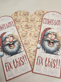 Two festive gift tags with a cartoon Santa Claus and text 'Cookies won't fix this!!' on a patterned background.