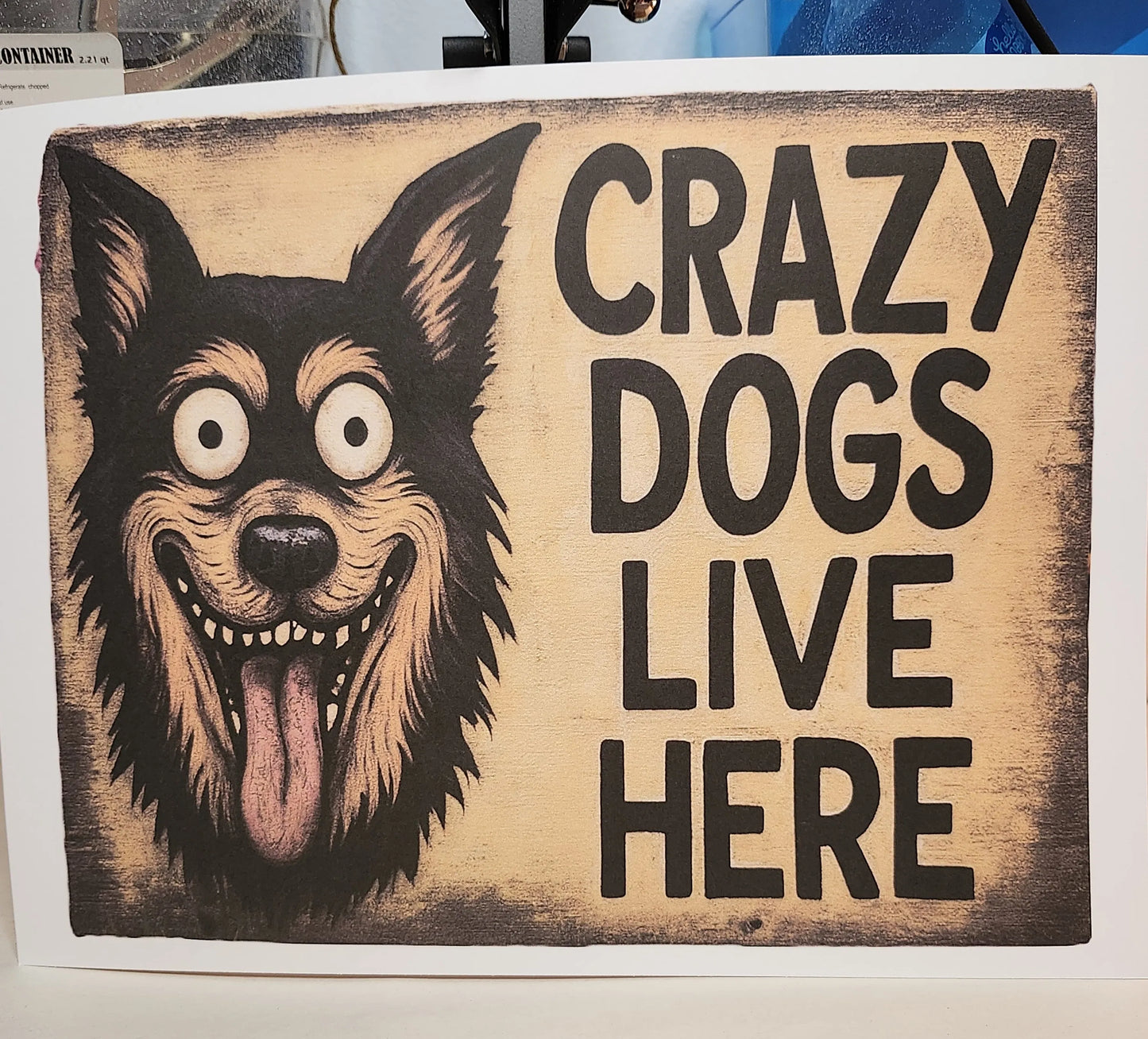 Wooden sign with a dog illustration and text 'Crazy Dogs Live Here' on a white background.