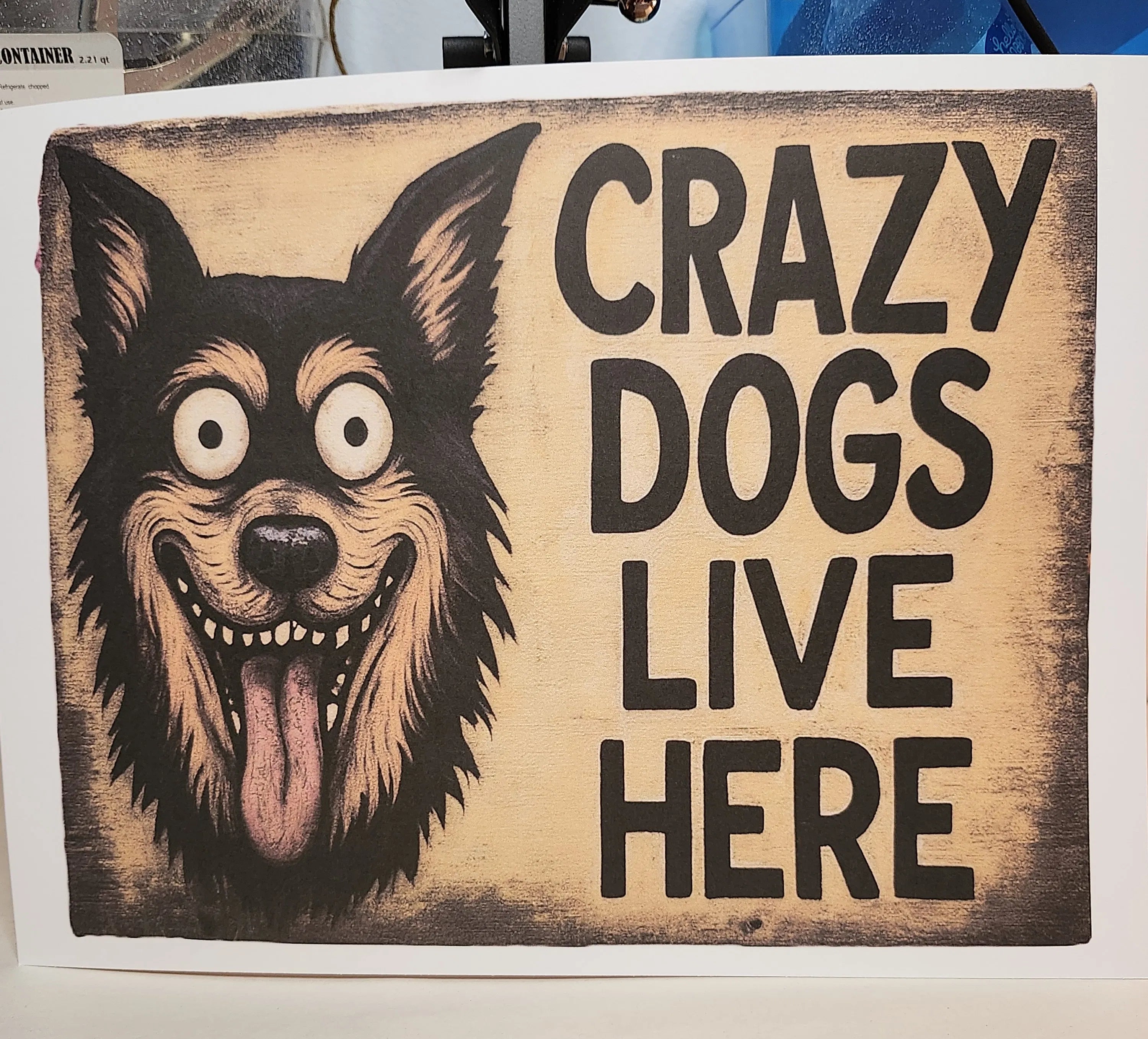 Wooden sign with a dog illustration and text 'Crazy Dogs Live Here' on a white background.