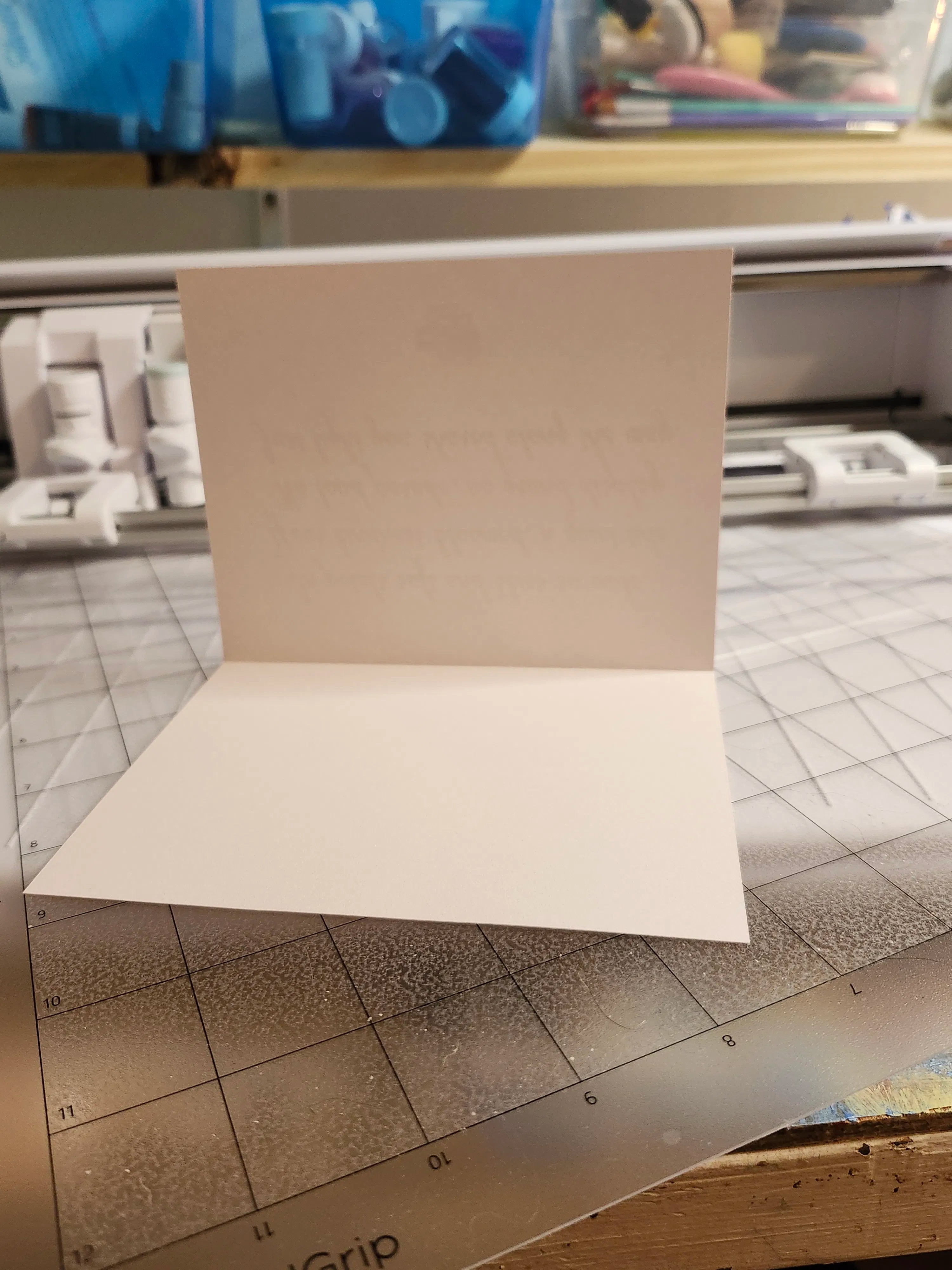 White paper on a cutting mat with a printer in the background