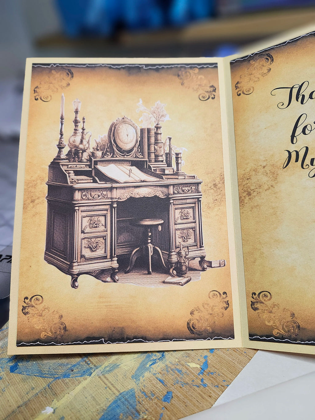 Open book with vintage desk illustration on a textured surface