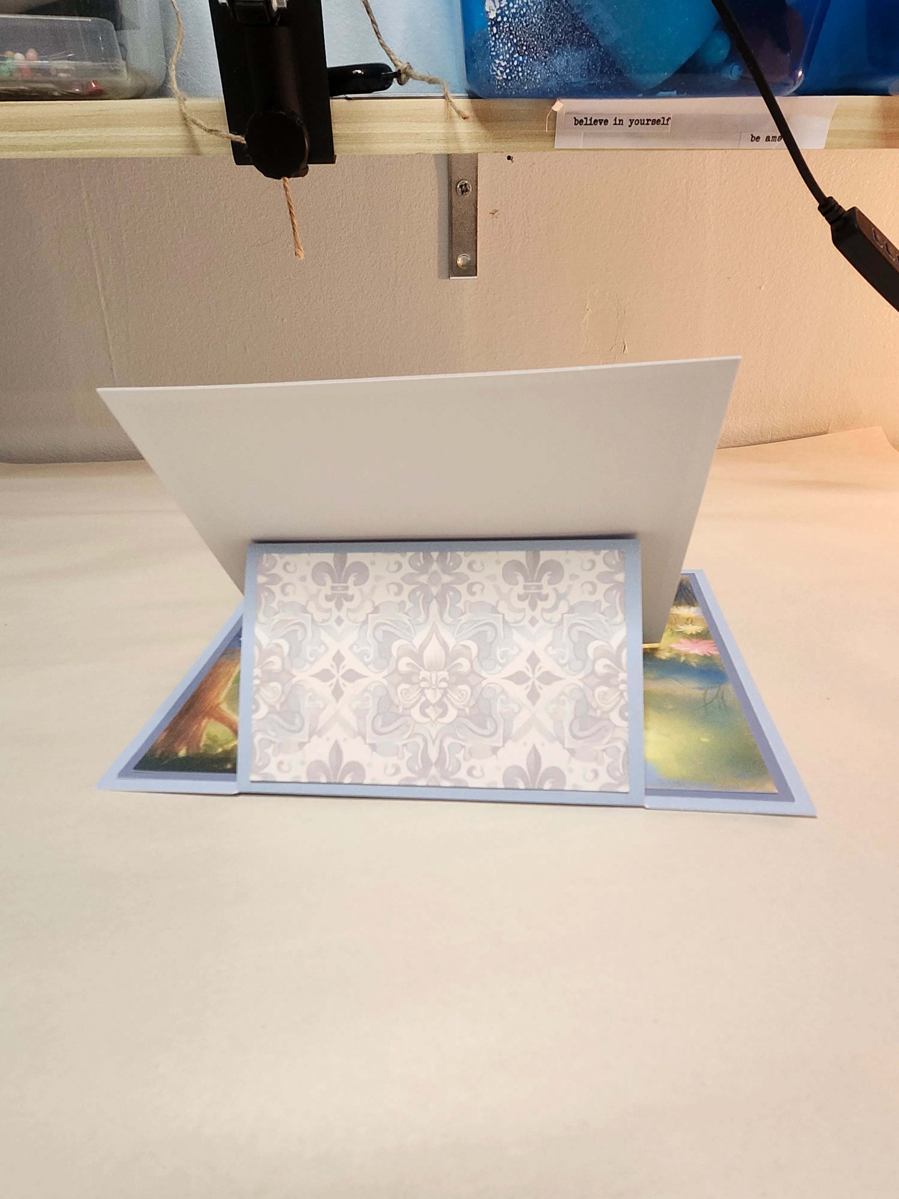 Open greeting card with floral design on a white surface
