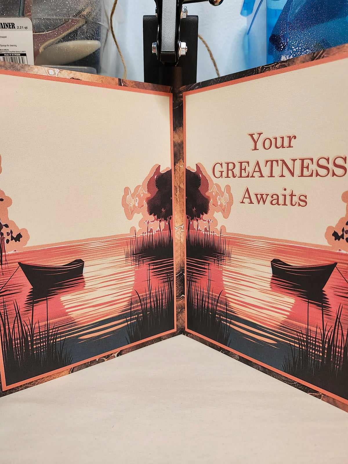 Card with silhouette design of boats and trees, featuring text 'Your GREATNESS Awaits'.