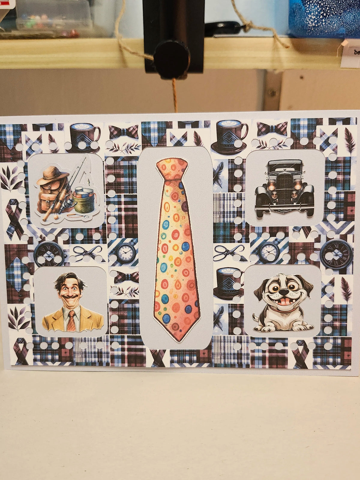 Collage of various illustrations including a tie, dogs, and other decorative elements on a patterned background.