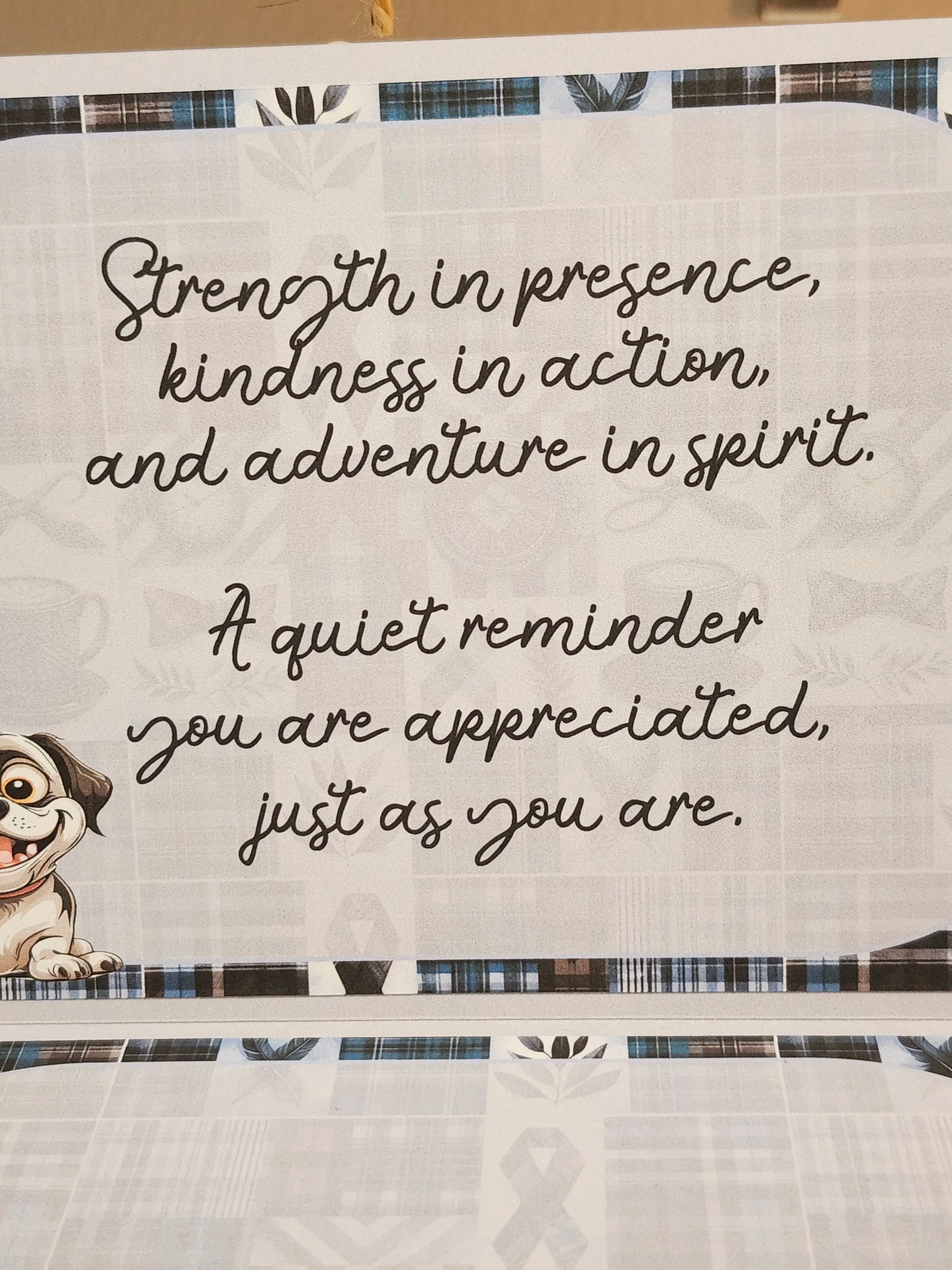 Text on a fabric background with a cartoon dog character, featuring motivational quote.
