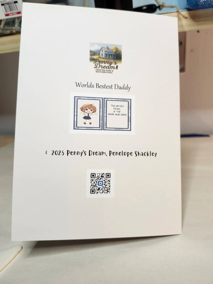 Card with 'Worlds Bestest Daddy' text and a QR code on a white surface.
