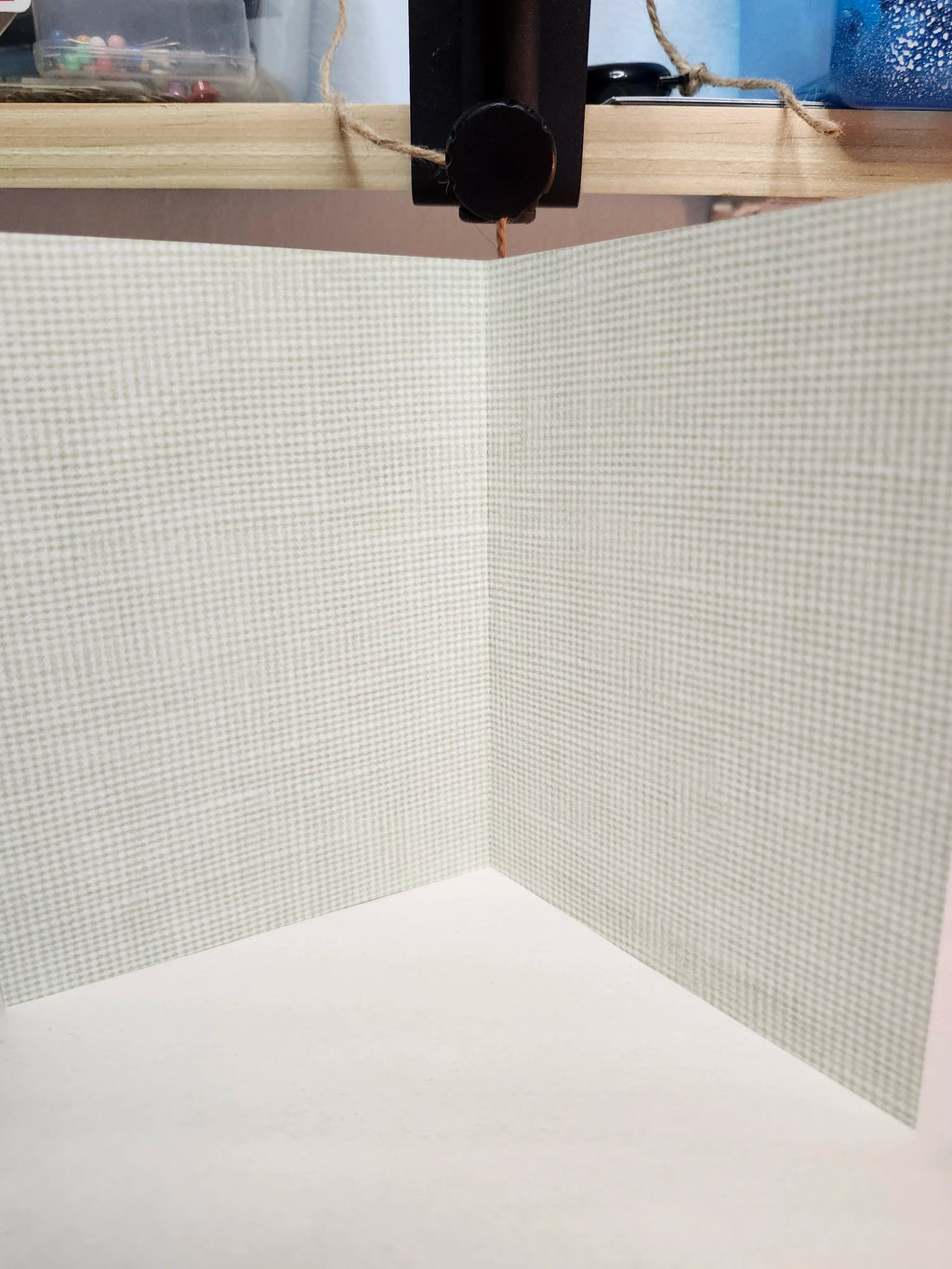 Close-up of a textured wall with a grid pattern and wooden frame.