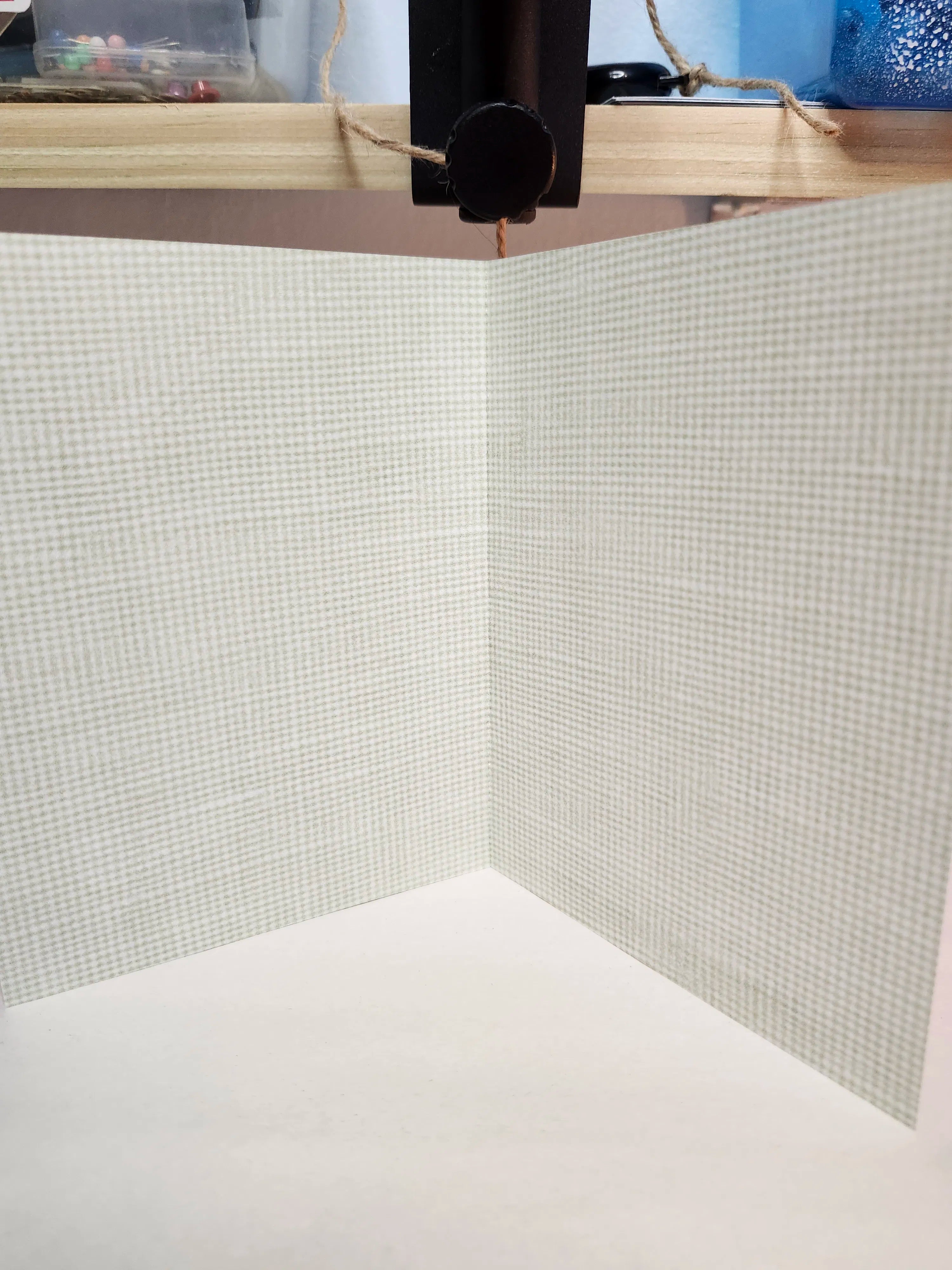 Close-up of a textured wall with a grid pattern and wooden frame.