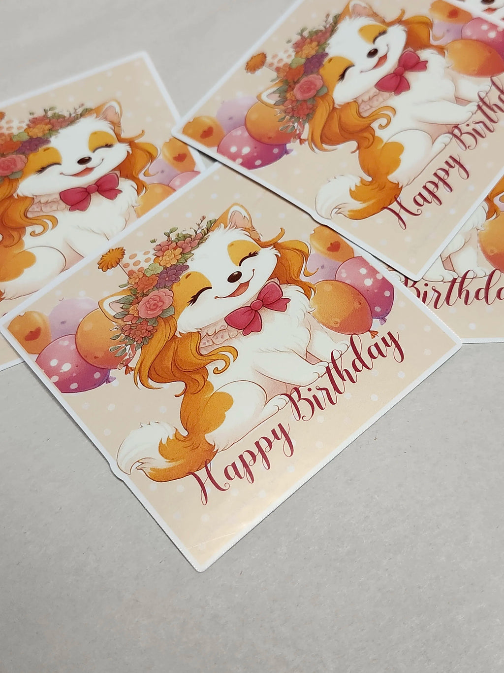 Three birthday cards with a cartoon dog and 'Happy Birthday' text on a gray surface.