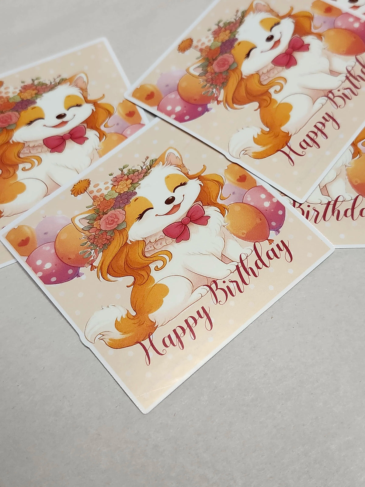 Three birthday cards with a cartoon dog and 'Happy Birthday' text on a gray surface.