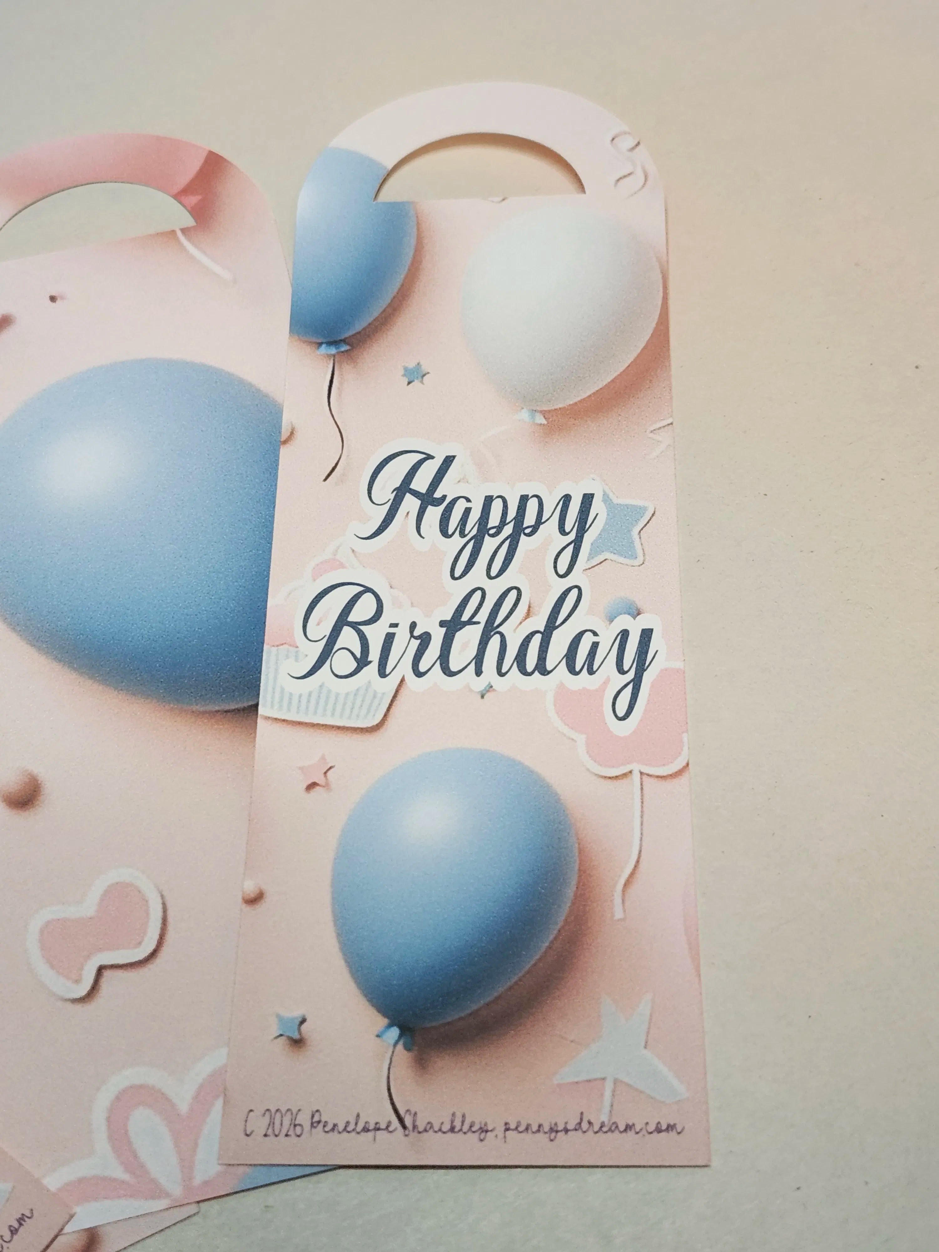 Happy Birthday card with blue balloons on a pink background